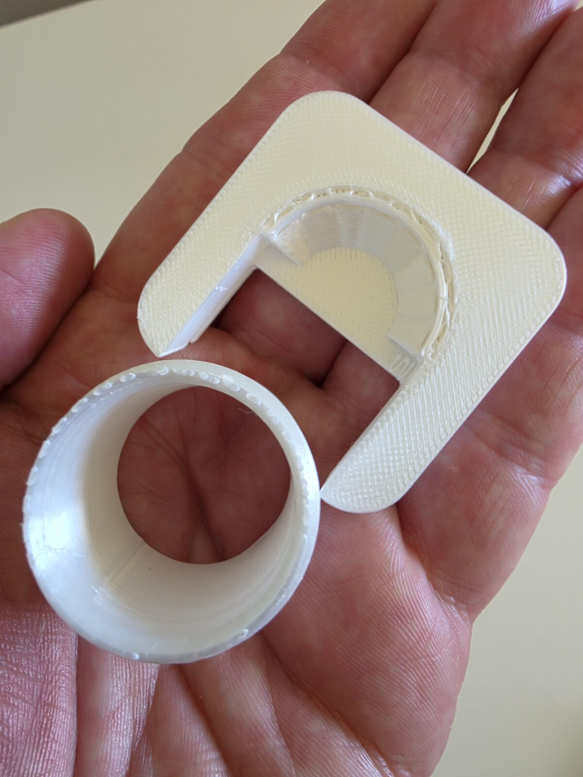 The cracked grommet — the tube sheared clean off the plate